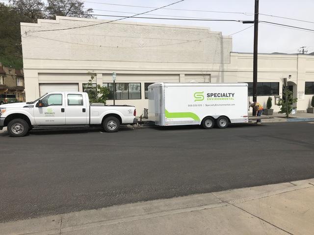 Specialty Environmental work truck and trailer, on site at a project.