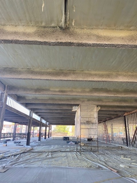 Spray foam insulation installed in the ceiling of a large parking garage for Gonzaga University.