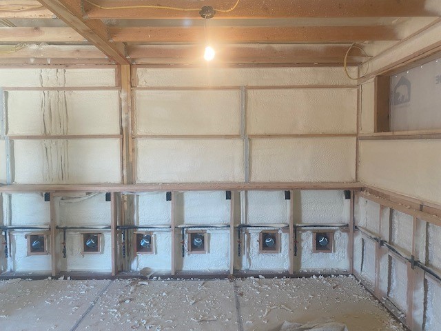 Inside an under construction laundromat with spray foam insulation