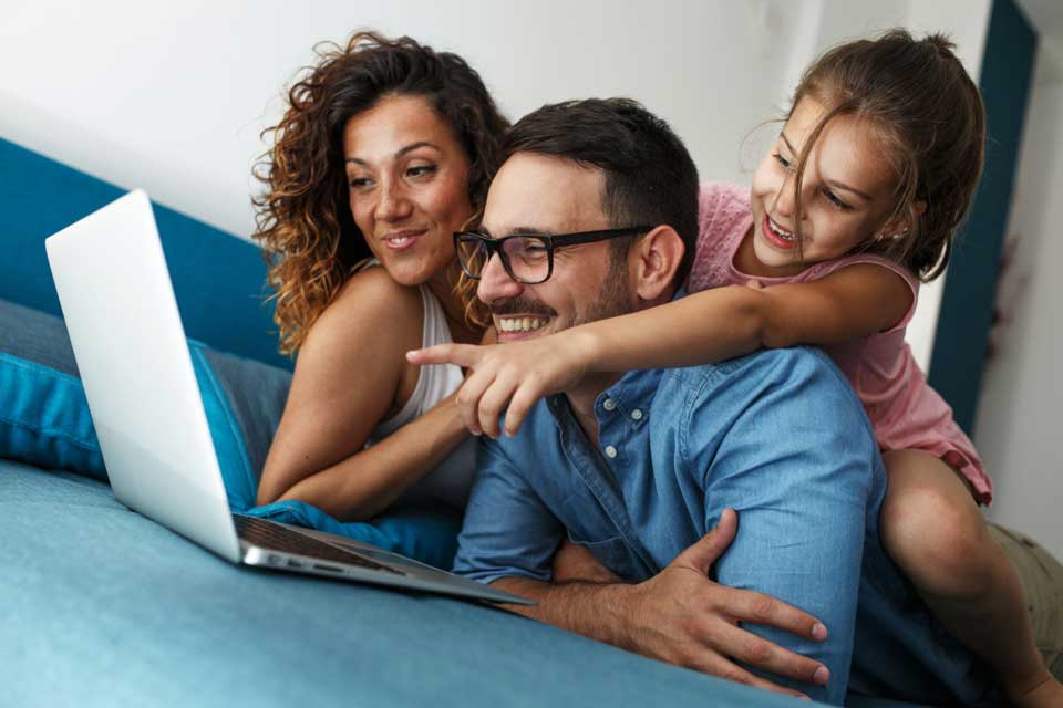 Happy family at home. Pictured, mom, dad, and daughter.