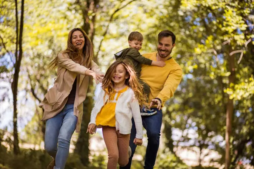 Happy family taking a walk through the woods, Uniontown, WA.